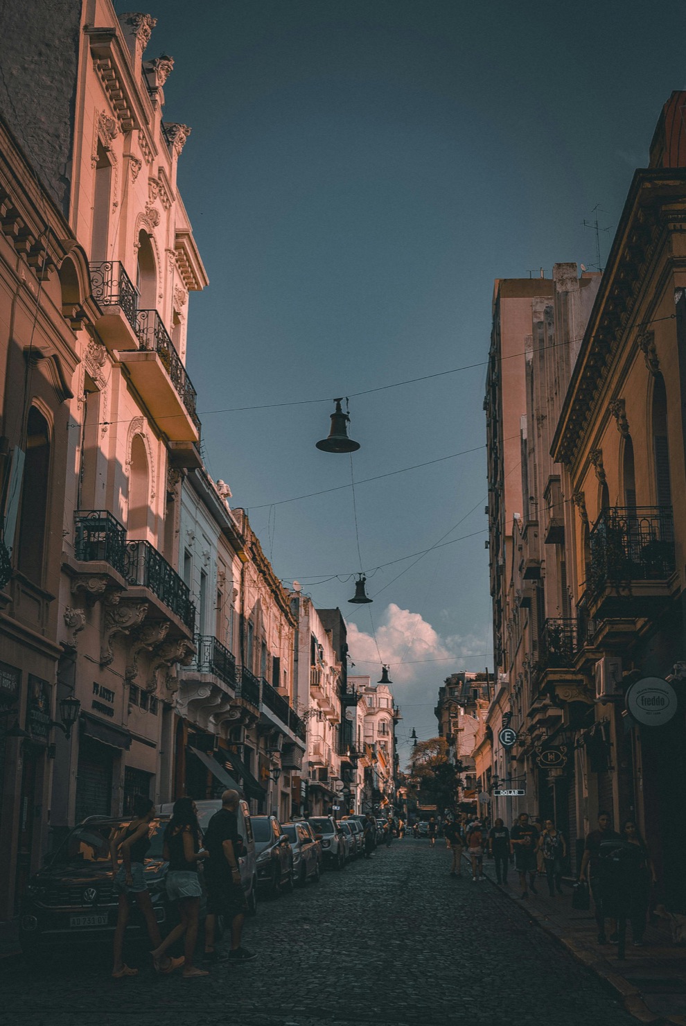 Cobblestone street of San Telmo at golden hour with hanging lamps, Buenos Aires
