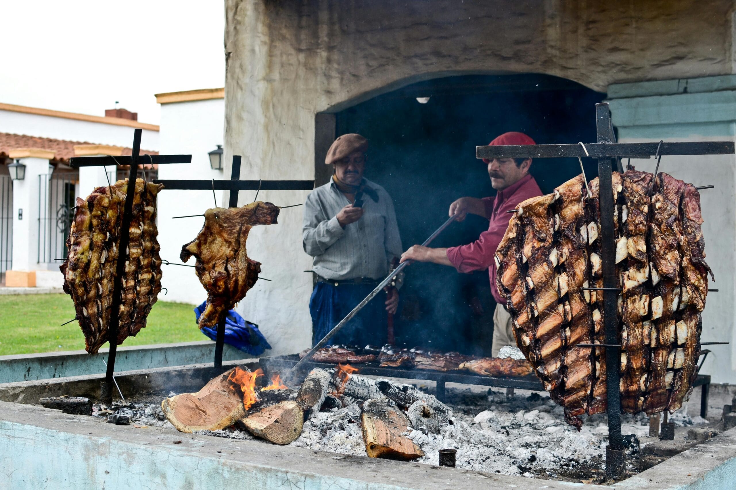 Argentine asado slow cooked on iron crosses over an open fire near Buenos Aires
