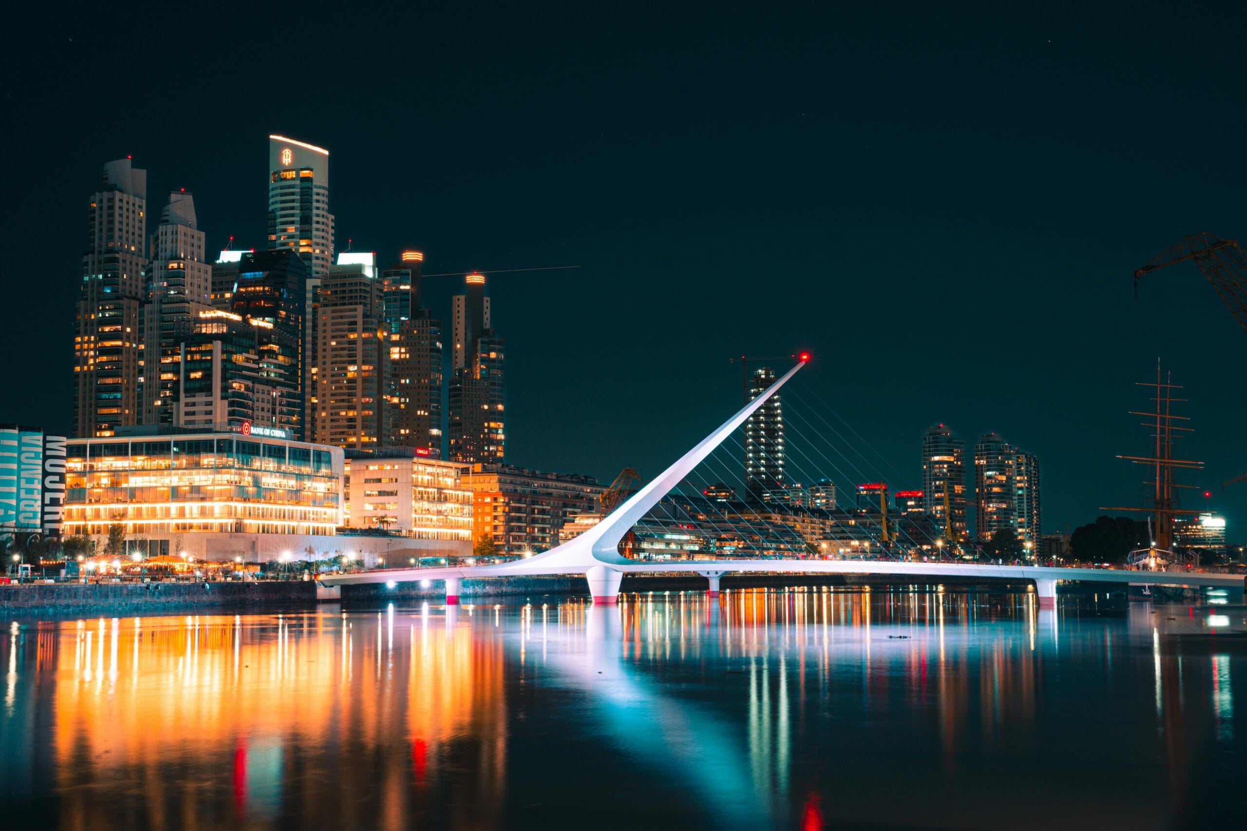 Puerto Madero and the Puente de la Mujer lit up at night, the Buenos Aires skyline seen on arrival