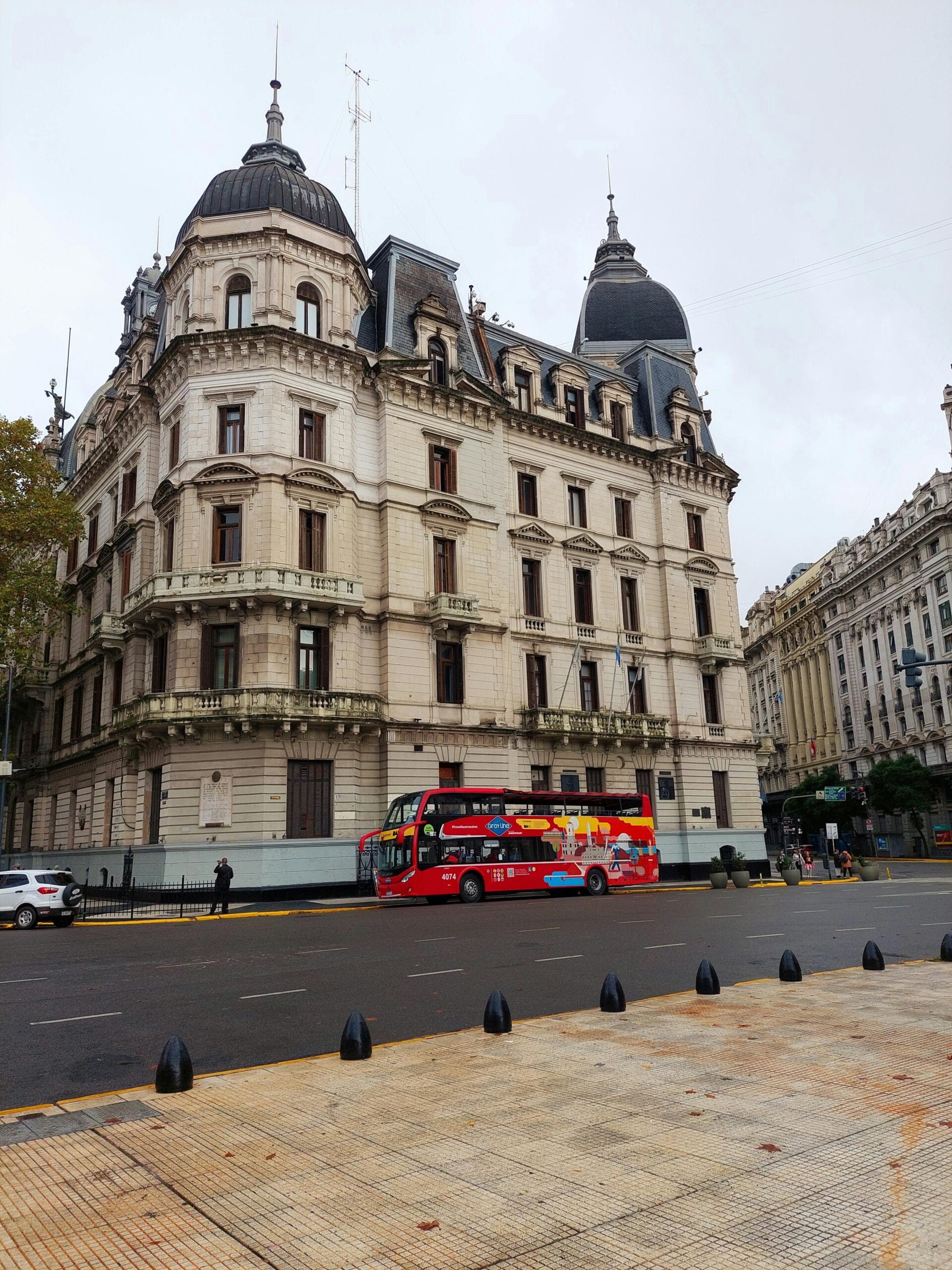 A sightseeing vehicle passing the architecture around Plaza de Mayo