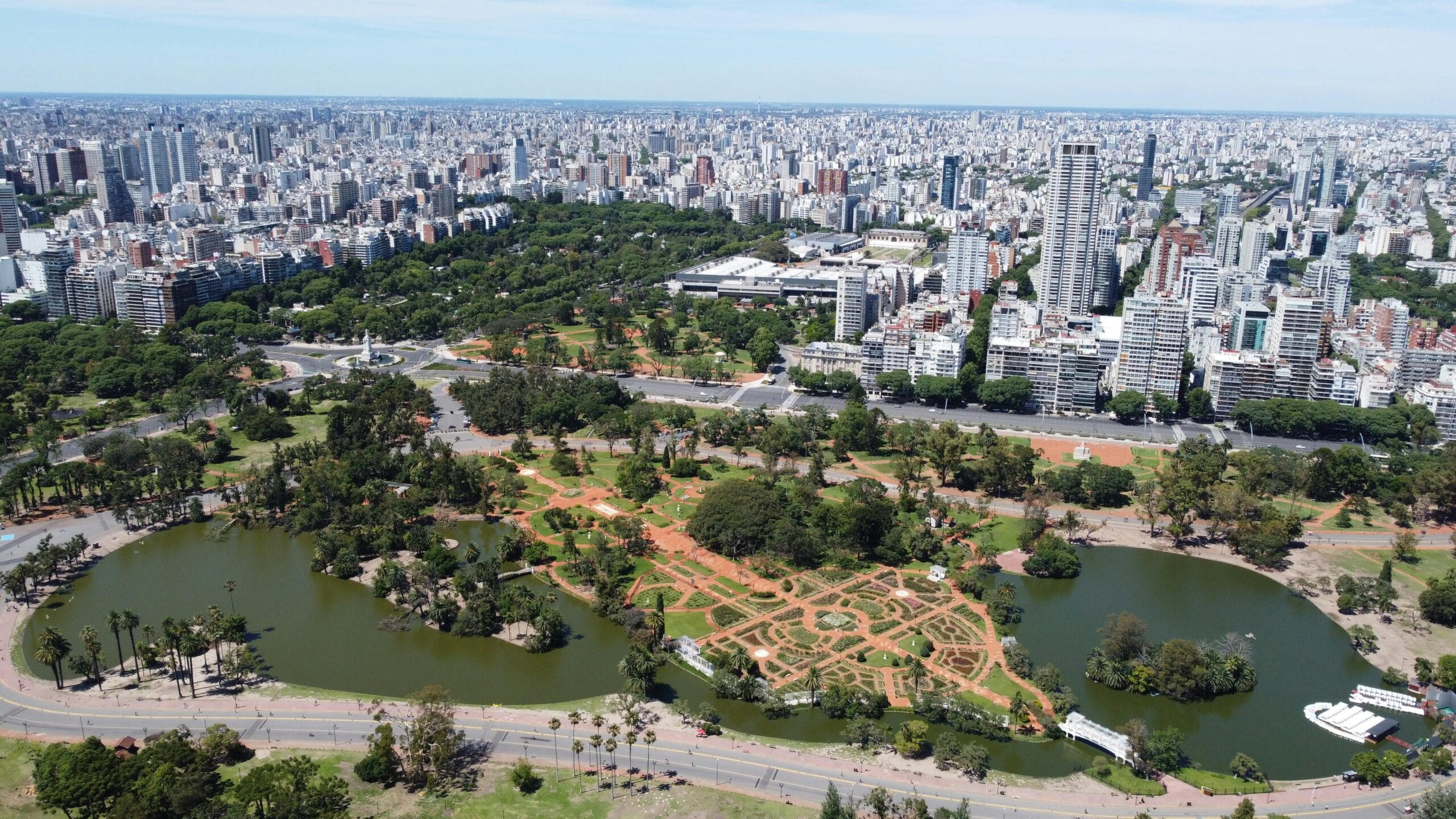 The Rosedal rose garden and its lake from the air, with the Palermo skyline behind