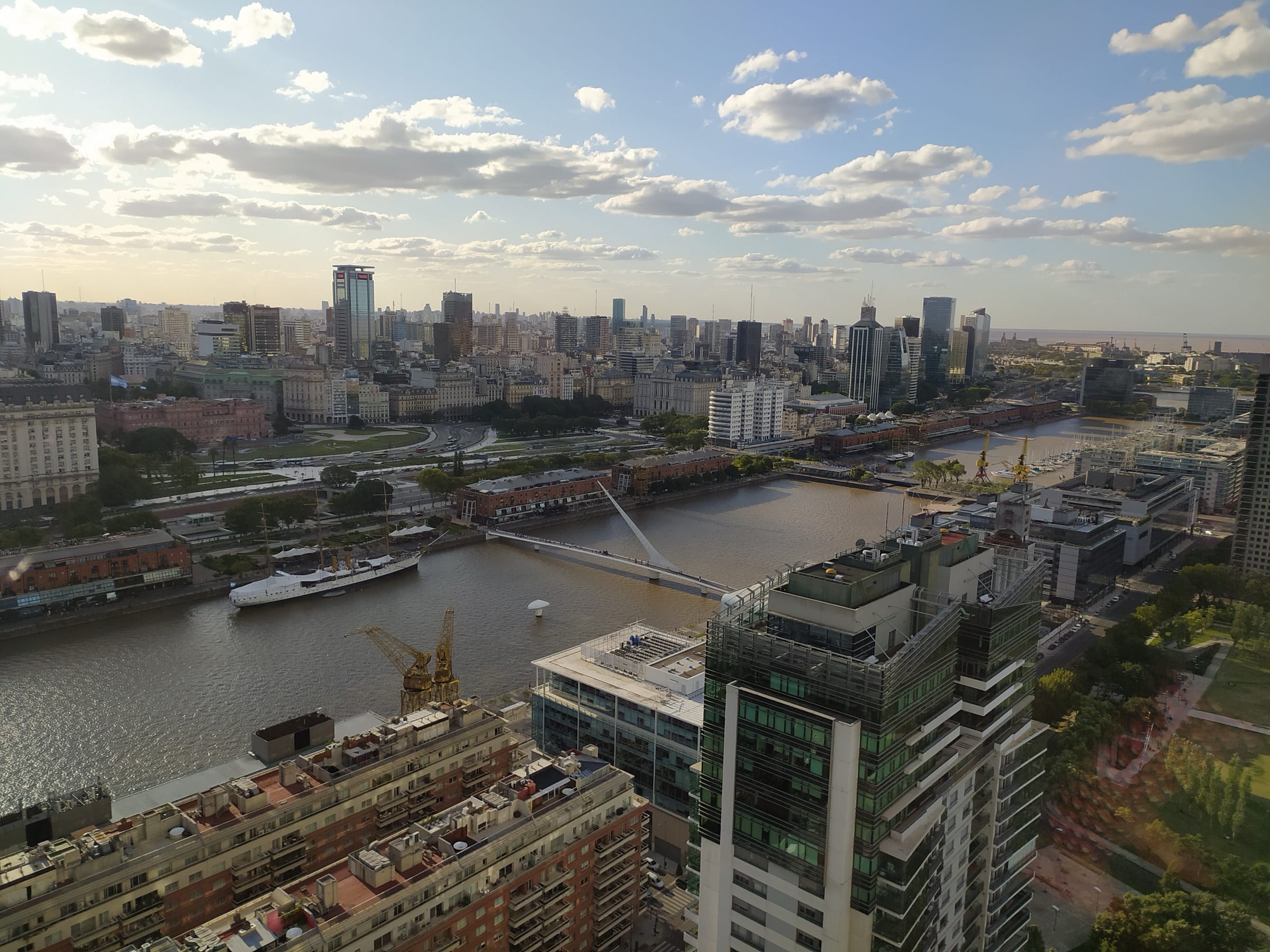 Puerto Madero and the Puente de la Mujer from above, with the Casa Rosada in the distance