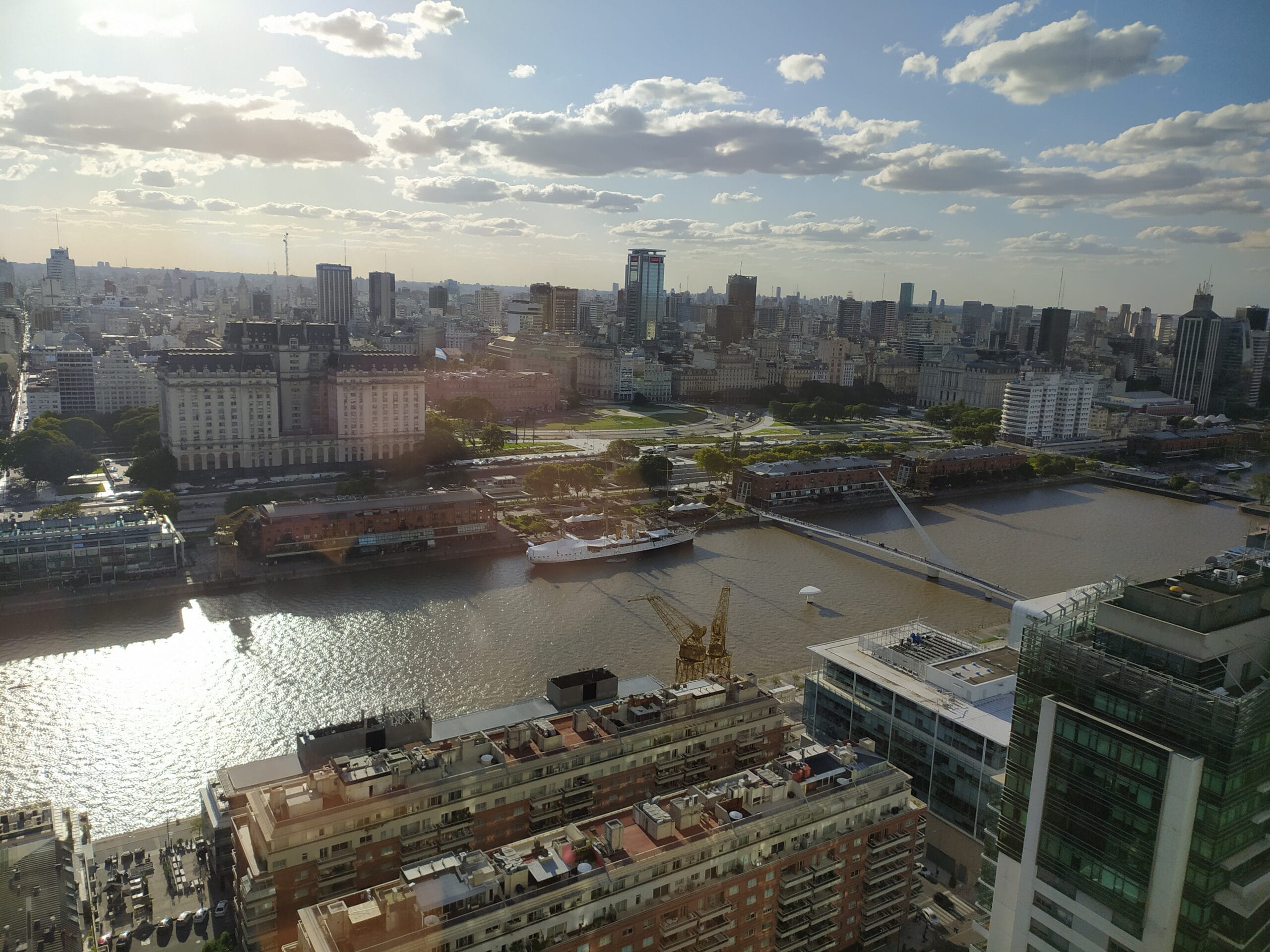 Puerto Madero's docks from above, with the Puente de la Mujer footbridge and the city centre behind them