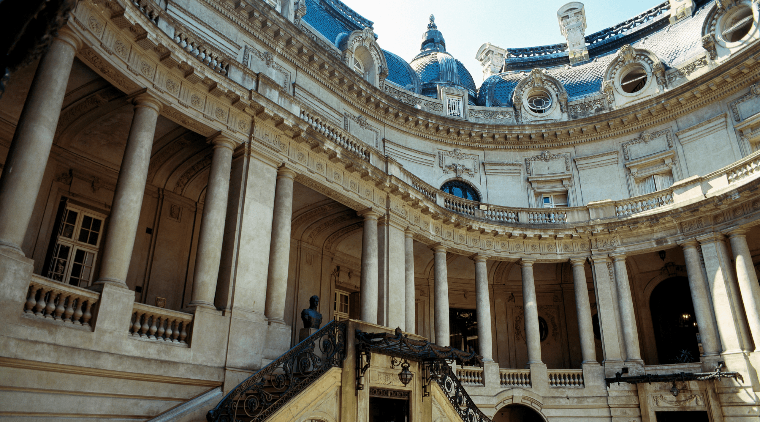 The stone facade and central courtyard of a Beaux-Arts palace in Buenos Aires