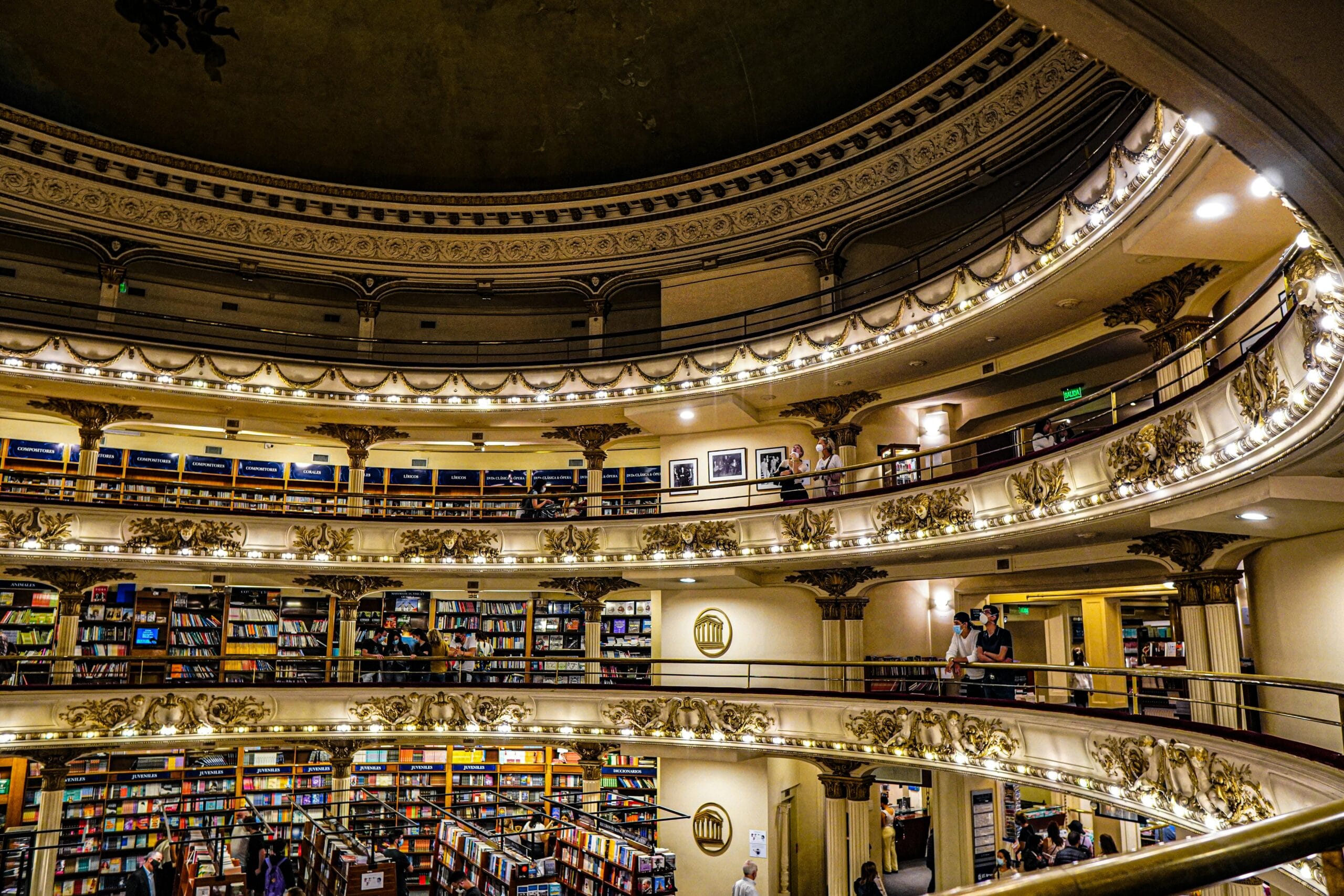 The balconies, painted ceiling and stage of a converted theatre now filled with bookshelves