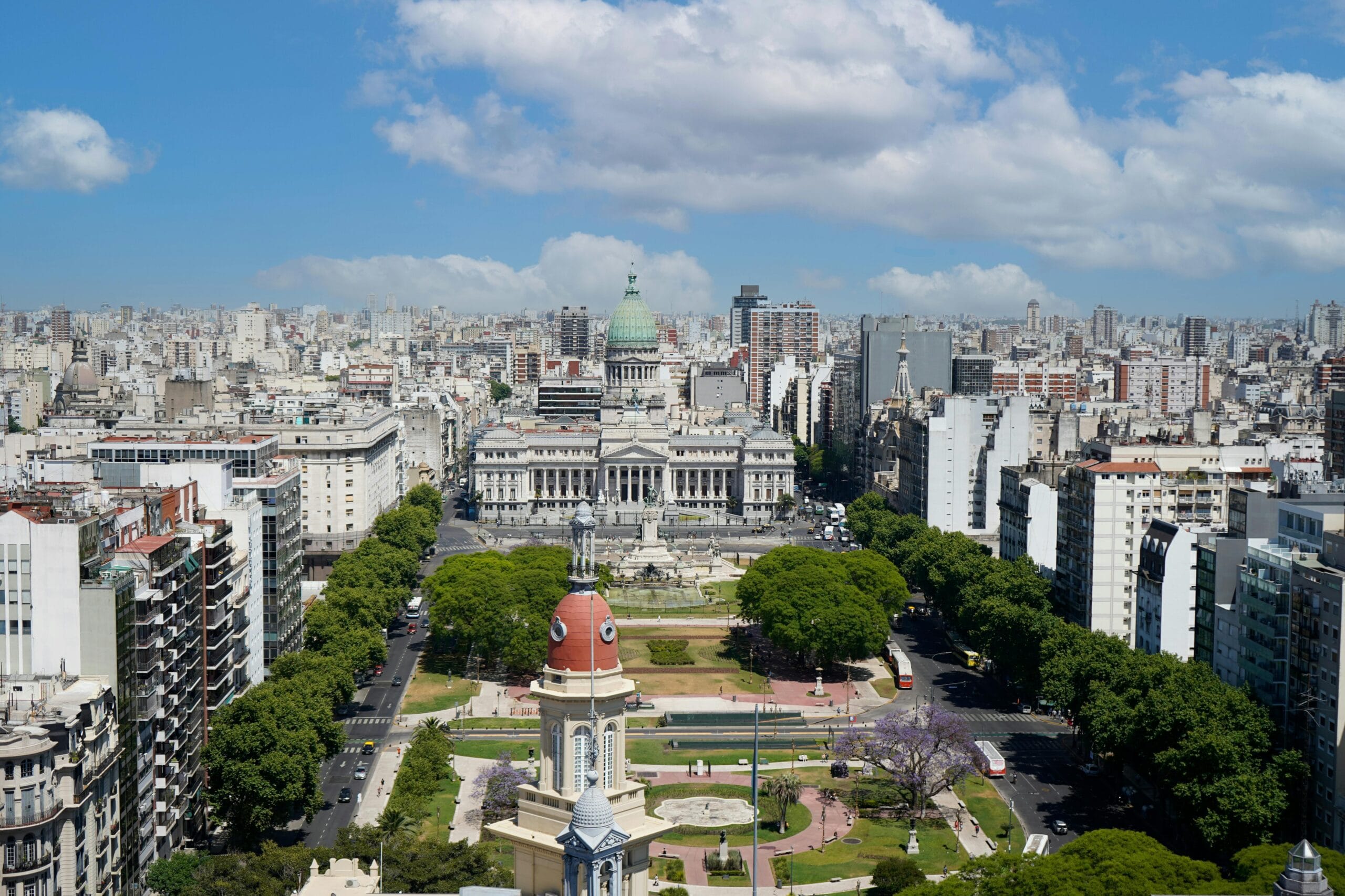The green dome of the National Congress rising above the Plaza del Congreso and the apartment blocks around it, seen from high above